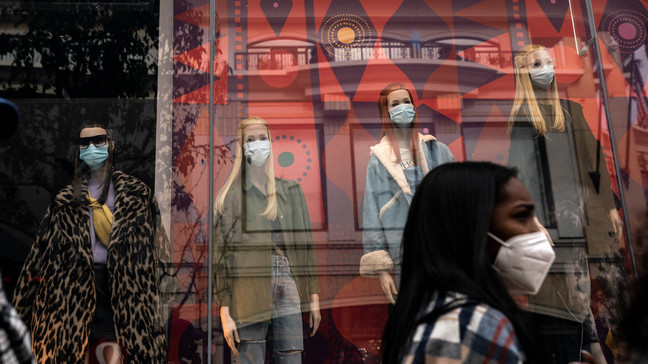 FILE - A shopper walks past mannequins donning face masks in Los Angeles, on Dec. 7, 2020. California's COVID-19 emergency declaration ends on Tuesday, Feb. 28, 2023. Public health experts say the pandemic has not ended, but the virus is much more manageable with the availability of vaccines and other treatments. (AP Photo/Jae C. Hong, File)