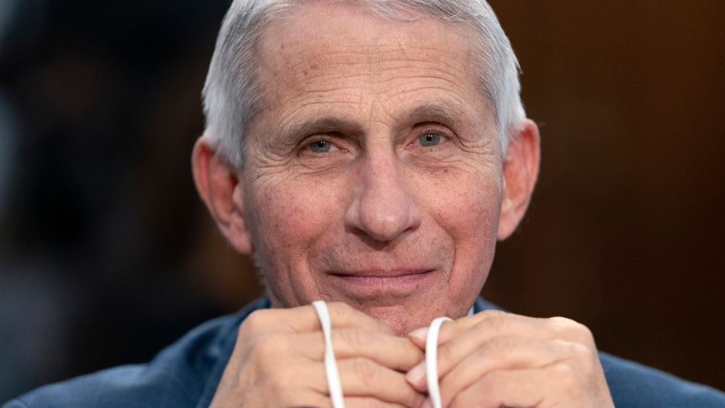 FILE - Dr. Anthony Fauci, Director of the National Institute of Allergy and Infectious Diseases, holds his face mask in his hands as he attends a House Committee on Appropriations subcommittee hearing on about the budget request for the National Institutes of Health, May 11, 2022, on Capitol Hill in Washington. Fauci, the nation's top infectious disease expert who became a household name, and the subject of partisan attacks, during the COVID-19 pandemic, announced Monday he will depart the federal government in December after more than 5 decades of service. (AP Photo/Jacquelyn Martin, File)
