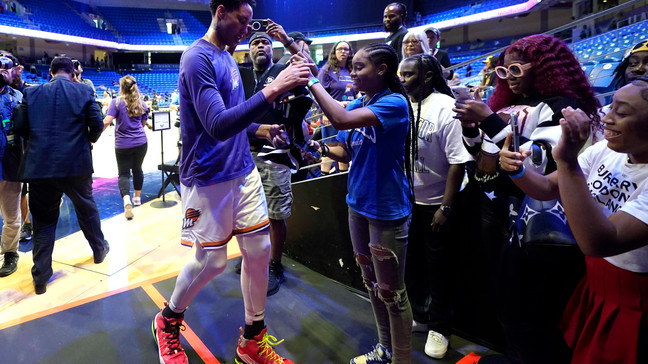 Phoenix Mercury's Brittney Griner, left, talks with fans after preparing for the team's WNBA basketball game against the Dallas Wings, Wednesday, June 7, 2023, in Arlington, Texas. (AP Photo/Tony Gutierrez)