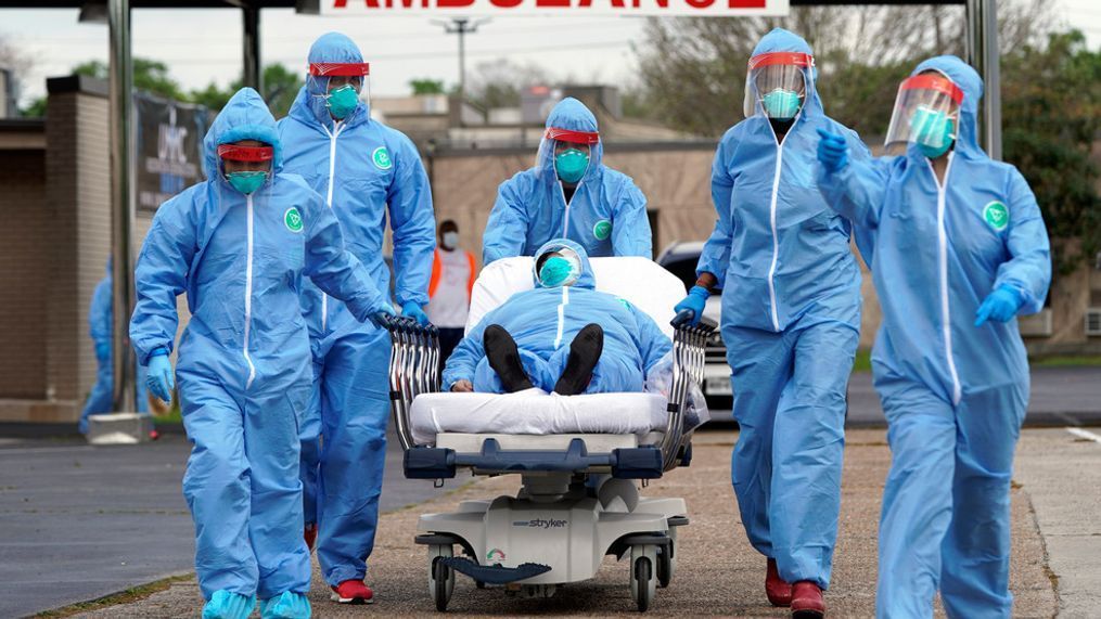 FILE - A person is taken on a stretcher into the United Memorial Medical Center after going through testing for COVID-19 Thursday, March 19, 2020, in Houston. (AP Photo/David J. Phillip, File)