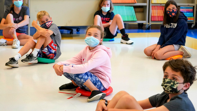 FILE - Fifth graders wearing face masks sit at proper social distancing during a music class at the Milton Elementary School in Rye, N.Y., May 18, 2021. (AP Photo/Mary Altaffer, File)
