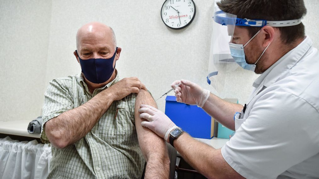 FILE - In this April 1, 2021, file photo Gov. Greg Gianforte receives a shot of the Pfizer COVID-19 vaccine from pharmacist Drew Garton at a Walgreen's pharmacy, in Helena, Mont. (Thom Bridge/Independent Record via AP, File)