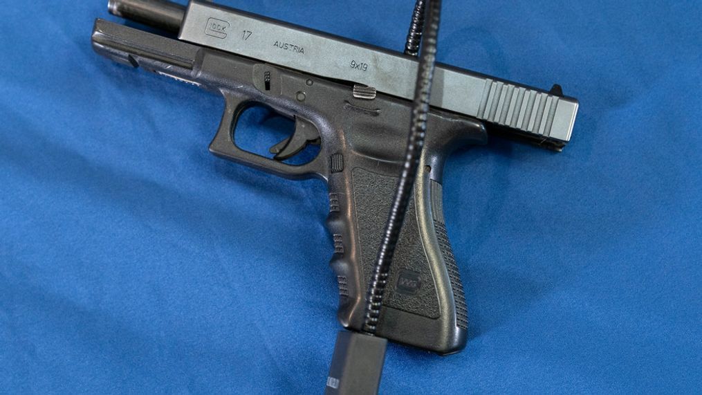 FILE - Displayed is a Glock 17 pistol fitted a with a cable style gun lock in Philadelphia, Wednesday, May 10, 2023. (AP Photo/Matt Rourke, File)