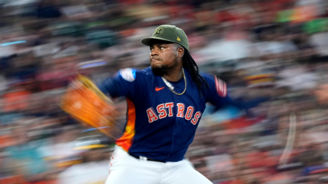 In this image taken with a slow shutter speed, Houston Astros' Framber Valdez throws against the Oakland Athletics during the fifth inning of a baseball game Sunday, May 21, 2023, in Houston. (AP Photo/David J. Phillip)
