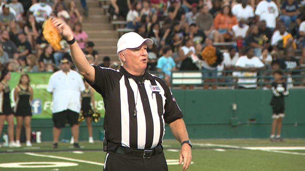 Football official Tim Griffin waves off a penalty flag.jpg
